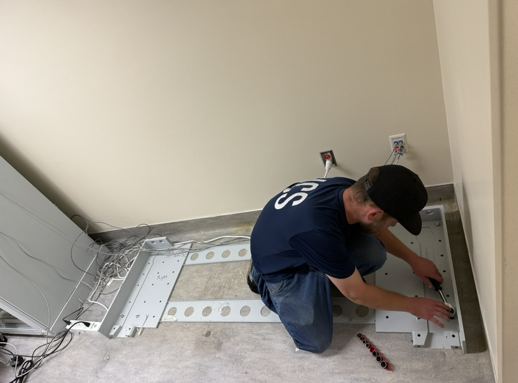 NCS crew member installing equipment at a healthcare facility
