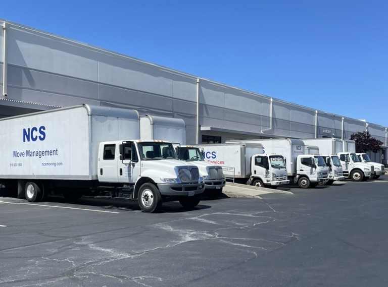NCS box truck fleet lined up outside the Oakland warehouse