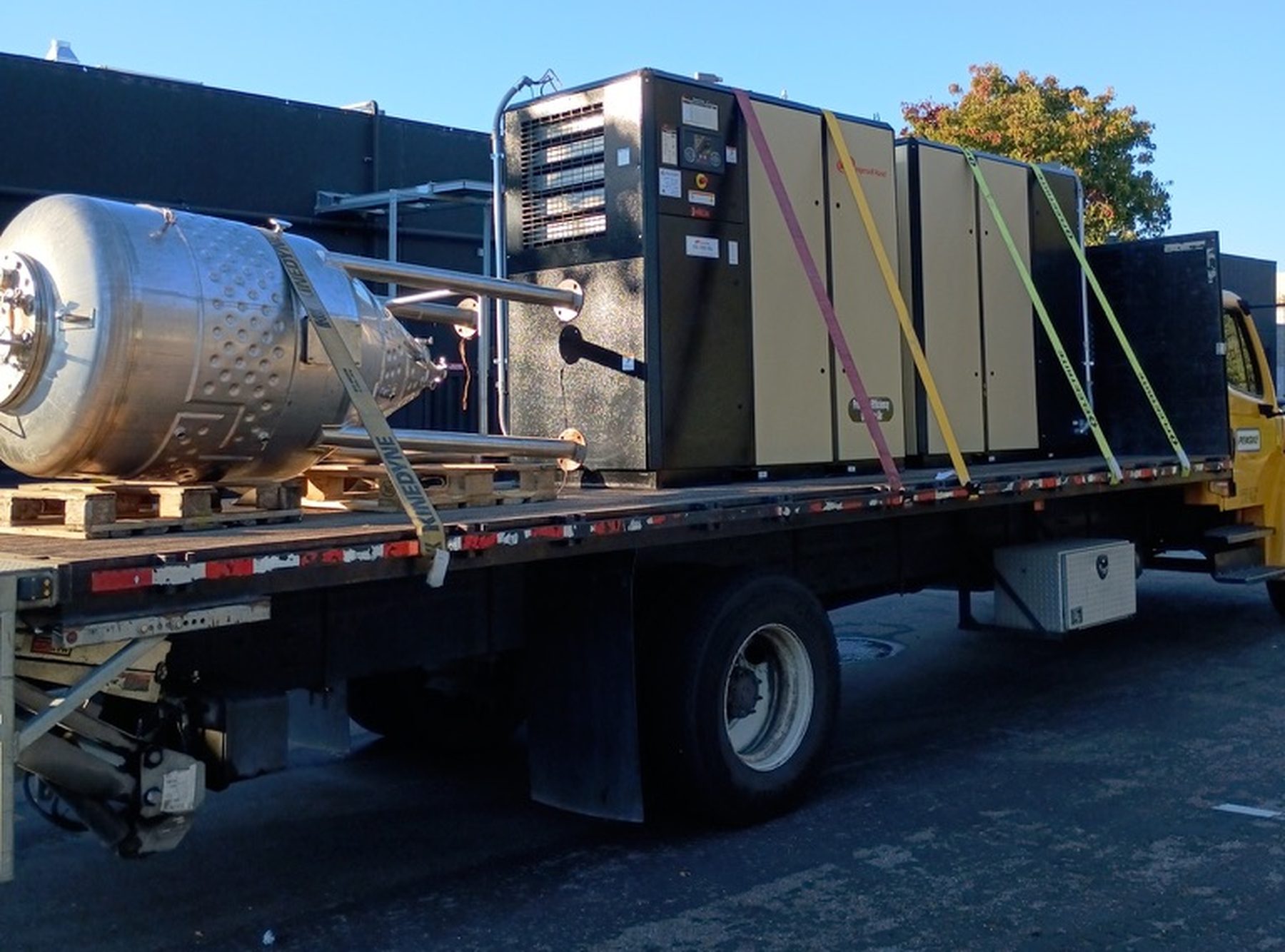 Industrial vessel and equipment rigged and strapped on a flatbed trailer