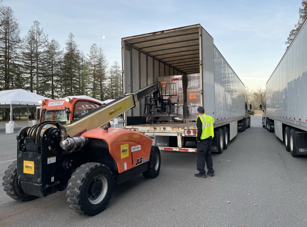 NCS telehandler operator loading palletized material into a trailer